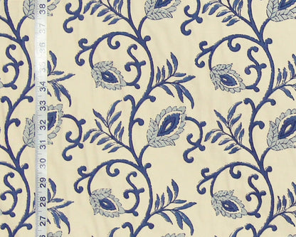 Blue floral pattern on beige fabric with a ruler for scale