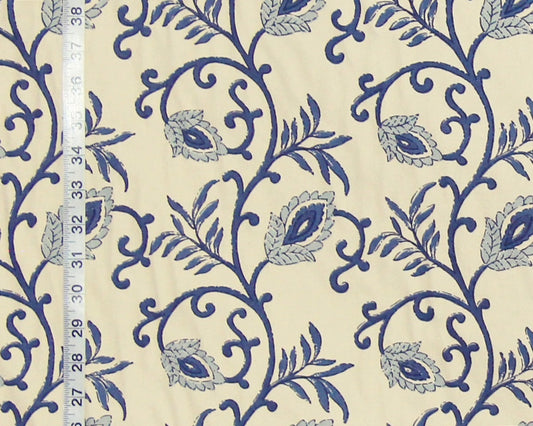 Blue floral pattern on beige fabric with a ruler for scale