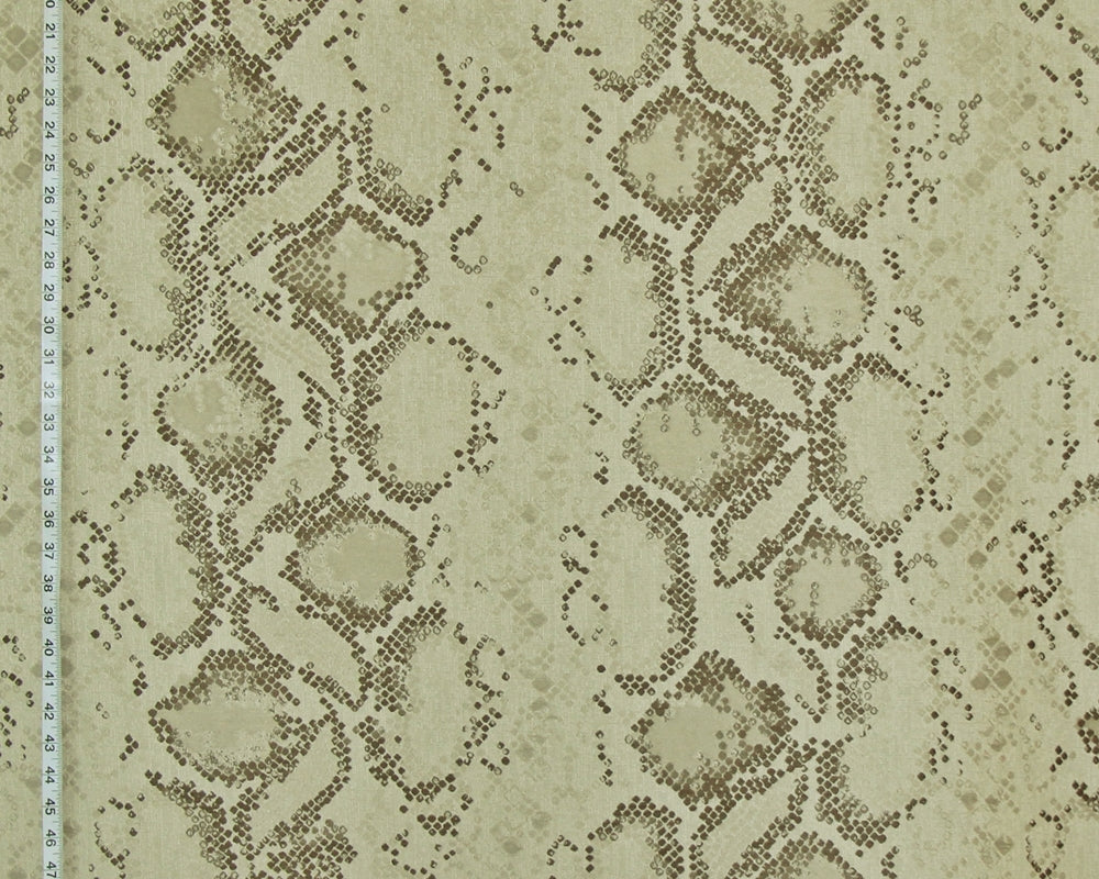 Beige and brown snakeskin pattern fabric with a scale design, shown with a measurement ruler on the left edge.