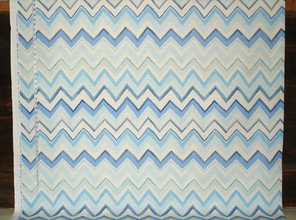 Fabric with blue and white zigzag pattern on a wooden background