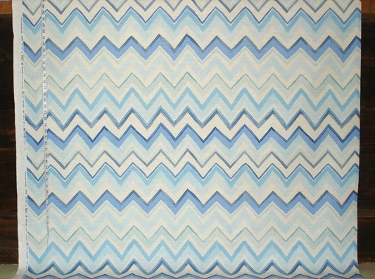 Fabric with blue and white zigzag pattern on a wooden background